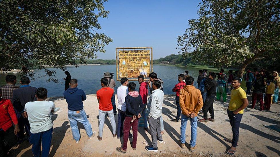 Residents of Maidan Garhi village near the pond where police allege Aftab Poonawala threw body parts of his friend Shraddha Walker. Photo from November 21, 2022