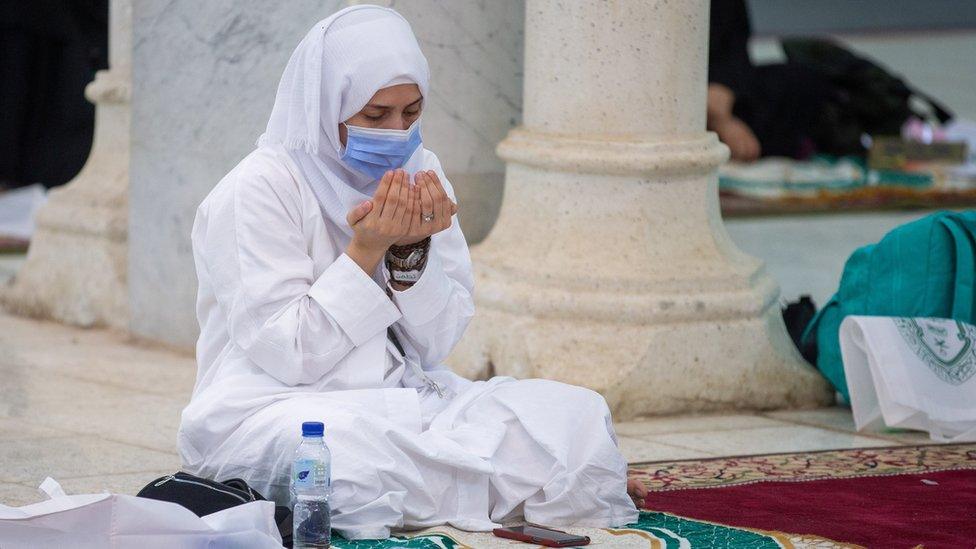 A Muslim pilgrim wears a mask as she prays inside the Namira Mosque in Arafat to mark the Hajj"s most important day, Day of Arafat (30 July 2020)