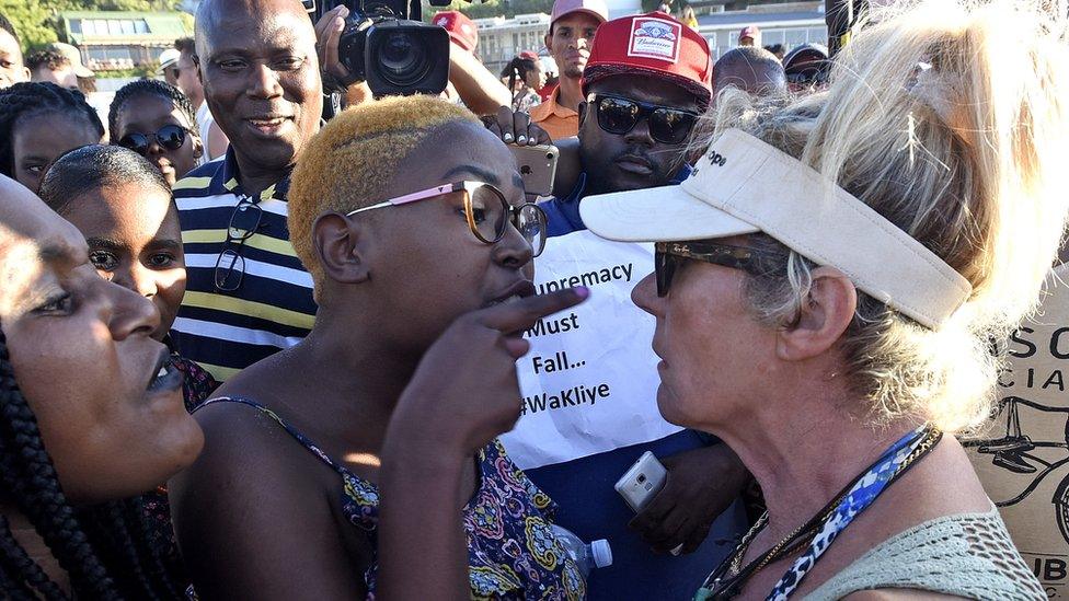 Protestors argue with an animal rights activist (R) before slaughtering a sheep during a protest on Clifton 4th beach in Cape Town, South Africa, 28 December 2018