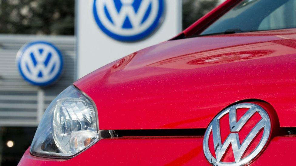 A red Volkswagen in front of a car dealer in Hanover, Germany