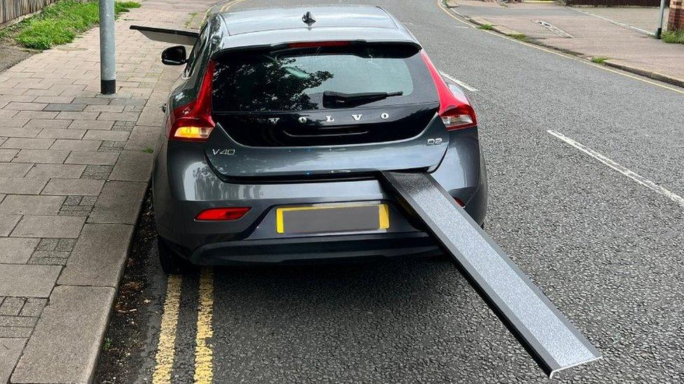 A car with an item poking out of it