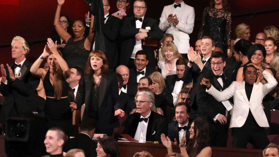 The cast of Moonlight celebrates as Moonlight wins the best picture award at the Oscars on Sunday, Feb. 26, 2017, at the Dolby Theatre in Los Angeles.