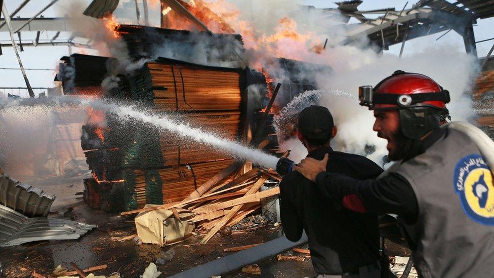 Syria Civil Defence first responders attempt to extinguish a fire after a reported air strike in Hamouria, Eastern Ghouta (28 November 2017)