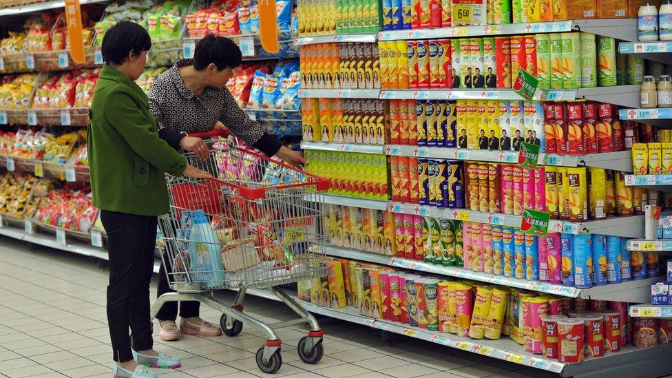 Customers select snacks at a supermarket in Fuyang, in eastern China's Anhui province