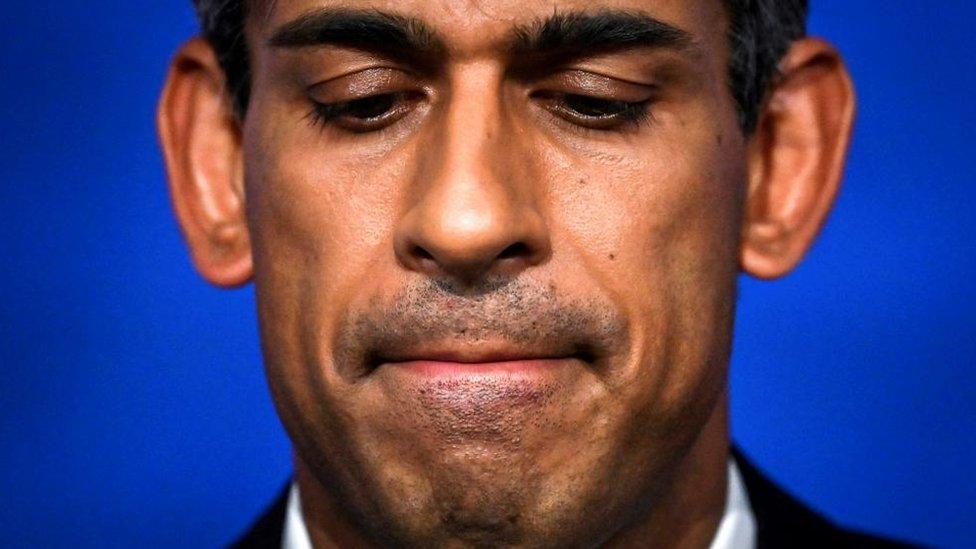 A close-up of the face of Prime Minister Rishi Sunak during a Downing St press conference