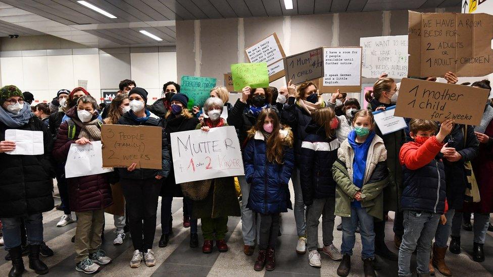 Crowds of people at Berlin station are offering places to arriving refugees