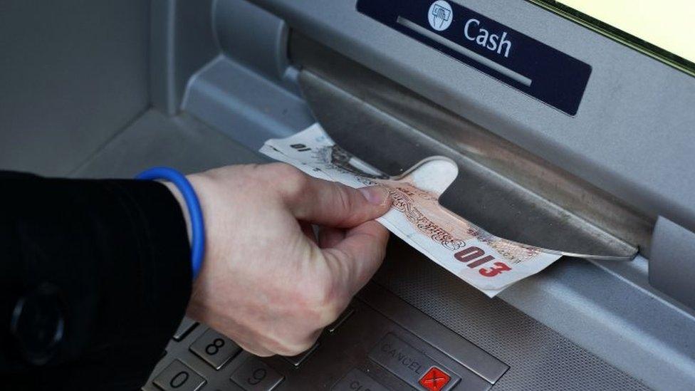 Money being taken out of a cash machine