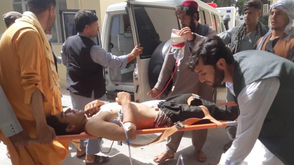 An Afghan worker of Halo Trust, working on a land mine clearance project, is transferred to an ambulance in Baghlan, Afghanistan, 09 June 2021