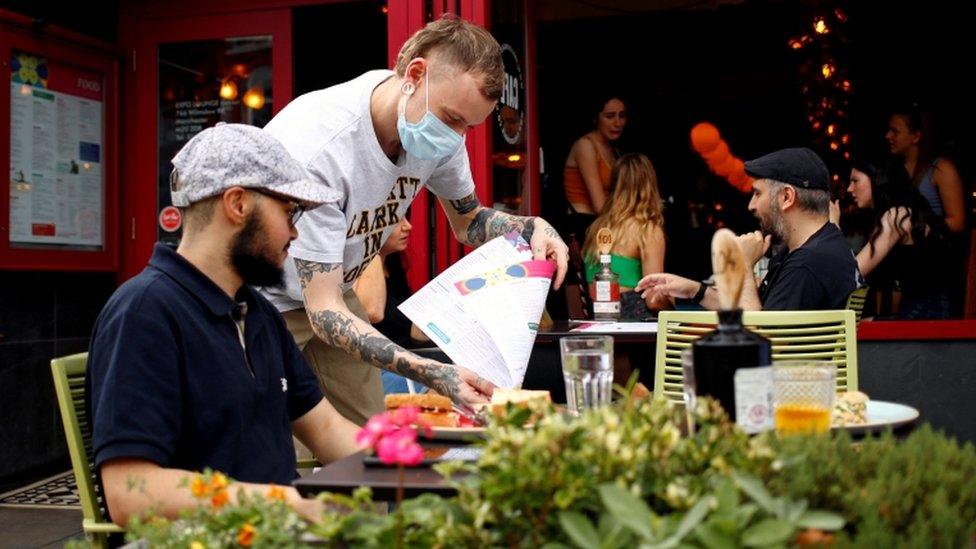 A diner has a lunch outside a restaurant in Didsbury, Manchester on 10 August 2020