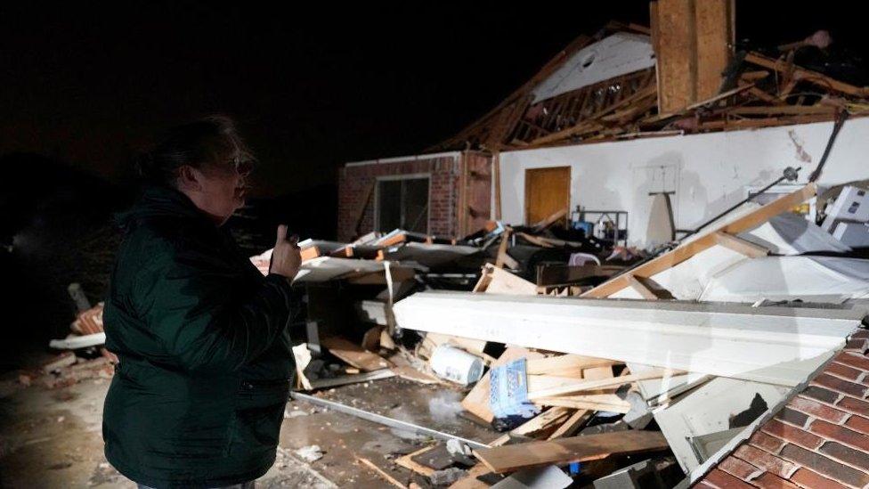 A woman looks over her home that was destroyed in Oklahoma on Sunday