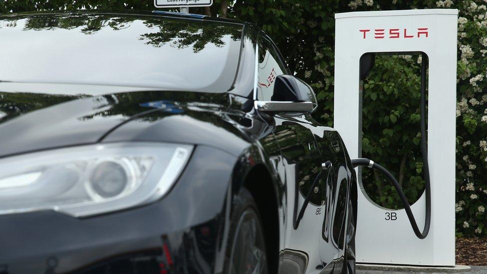 Tesla charging station with car