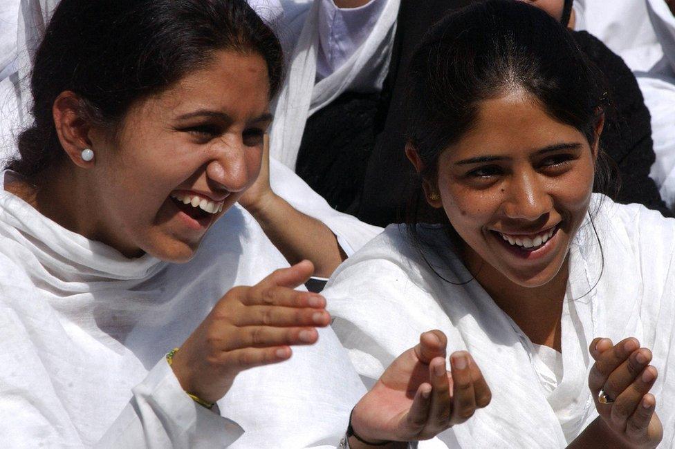 Kashmiri college girls cheer during a women's cricket match at the Women's College in Srinagar, 13 September 2005.