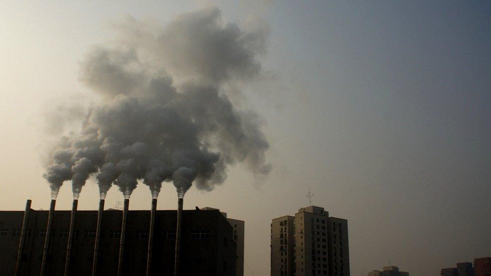 Factory chimneys giving off smoke in Beijing, China