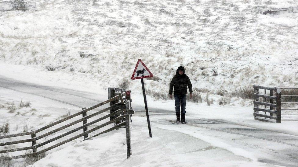 A person walks in the snow in Swaledale, North Yorkshire