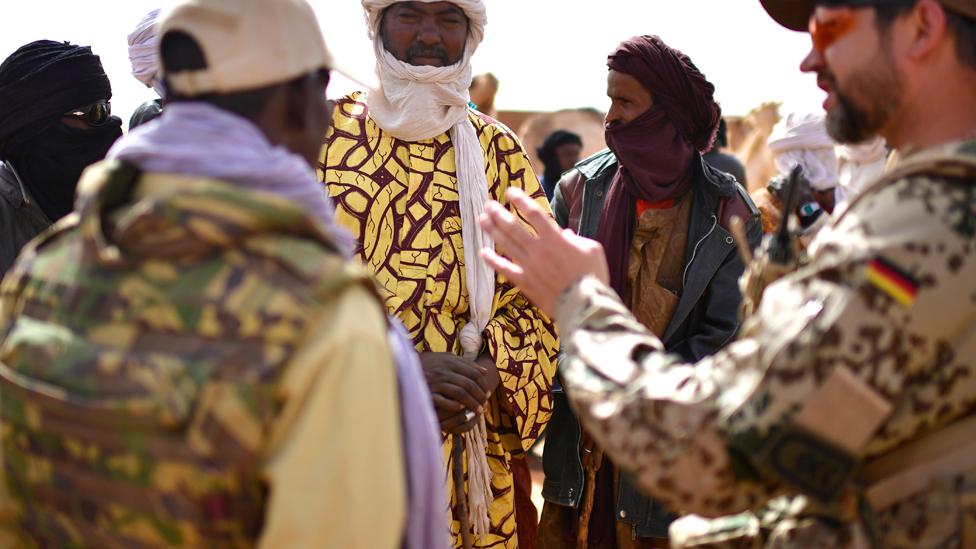 Farmers talk to German UN soldiers during a weekly cattle market on the outskirts of Gao, Mali - 2017