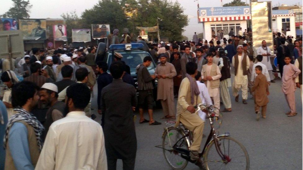 Alleged militants patrol on an Afghan police vehicle after the Taliban seized most of Kunduz city