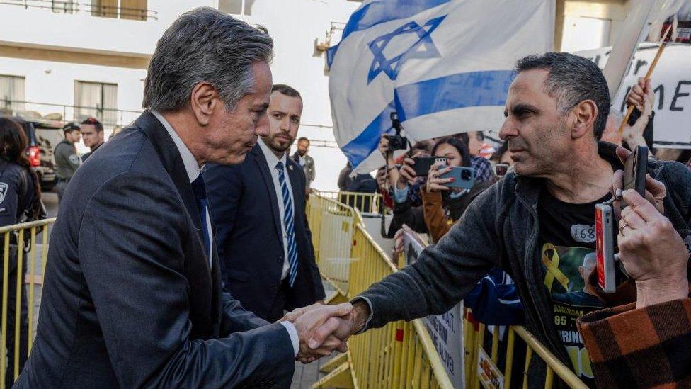 Secretary of State Antony Blinken shakes hands with a man in Tel Aviv, Israel, during a protest calling for the release of hostages kidnapped in the October 7 attack on Israel by the Palestinian Islamist group Hamas.