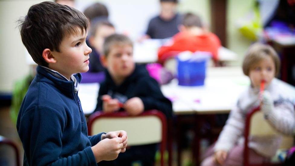 French boy standing up in class