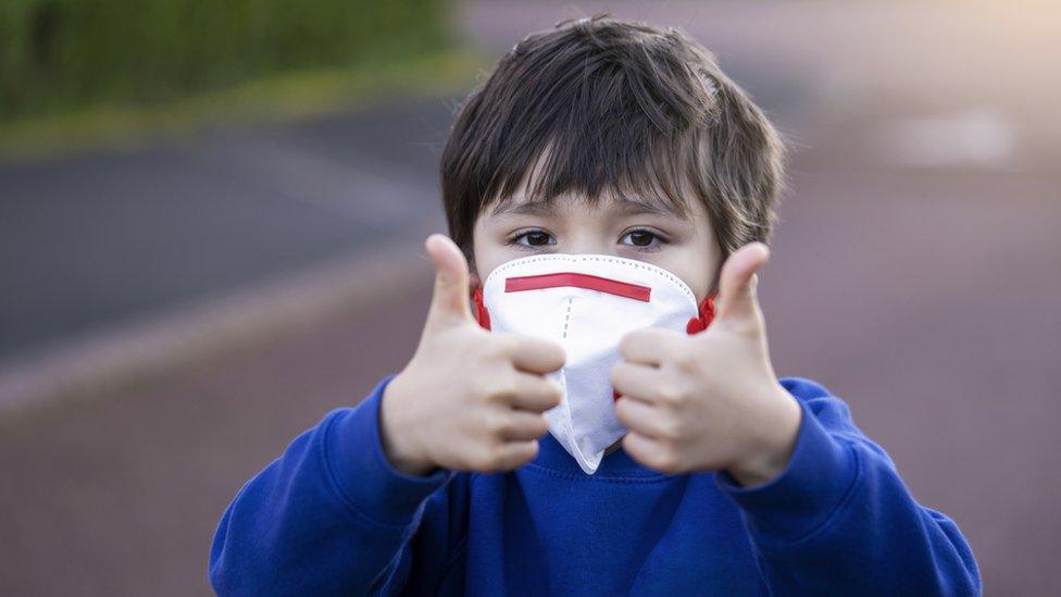 child in face mask