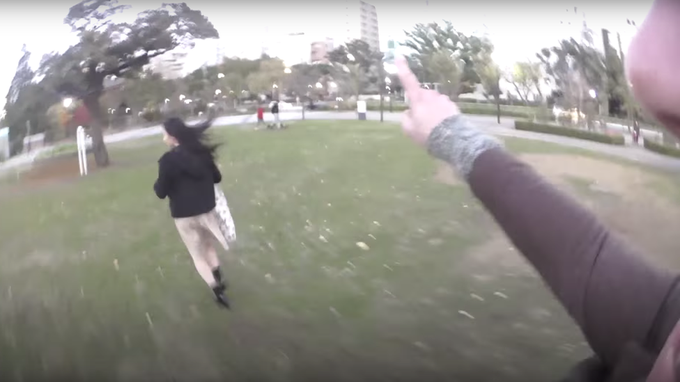 Woman pursued by man across park from video