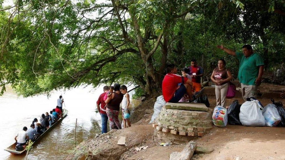 People wait their turn to cross to Boca del Grita in Venezuela, over a river that marks the border near Puerto Santander, Colombia, June 3, 2016