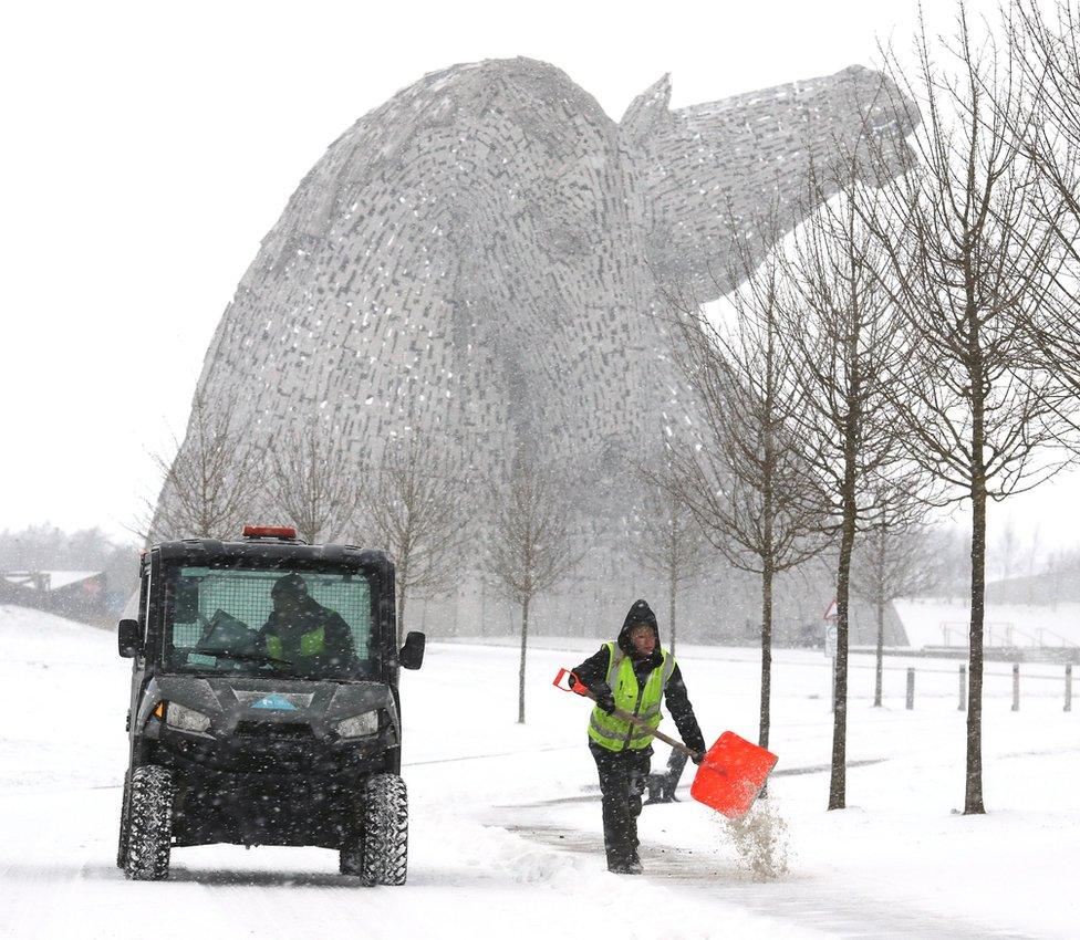 People grit the paths near the Kelpies in Helix Park, Falkirk