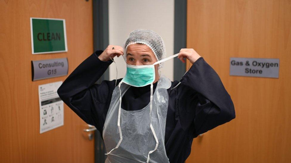 Doctor putting on a facemask