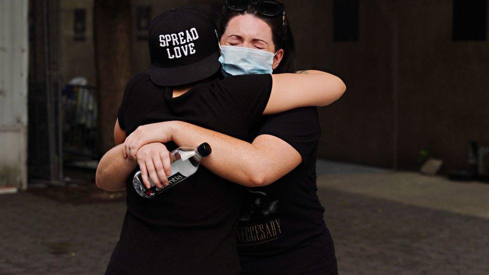 People embrace during the coronavirus pandemic on May 29, 2020 in New York City