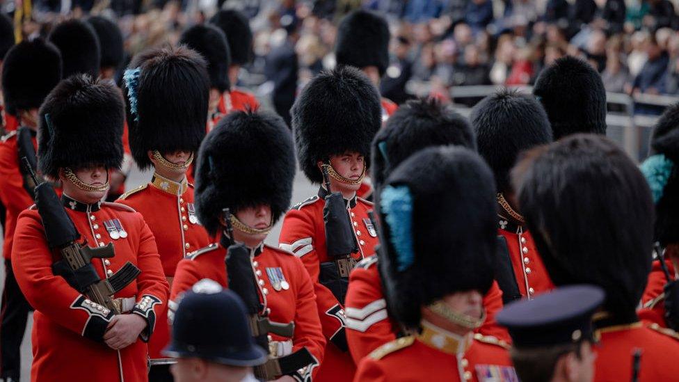 Queen's guard in traditional red and black uniform