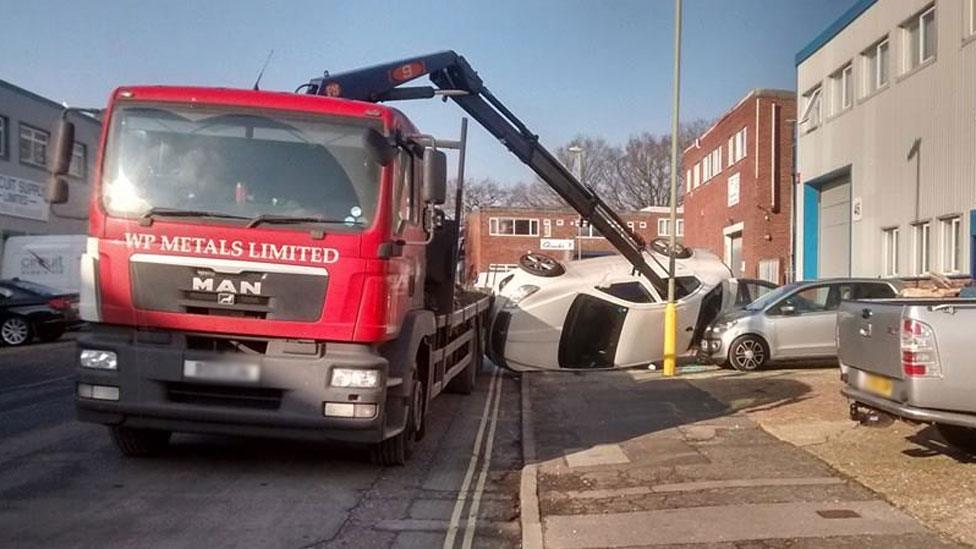 The lorry with the crane through the window of a car