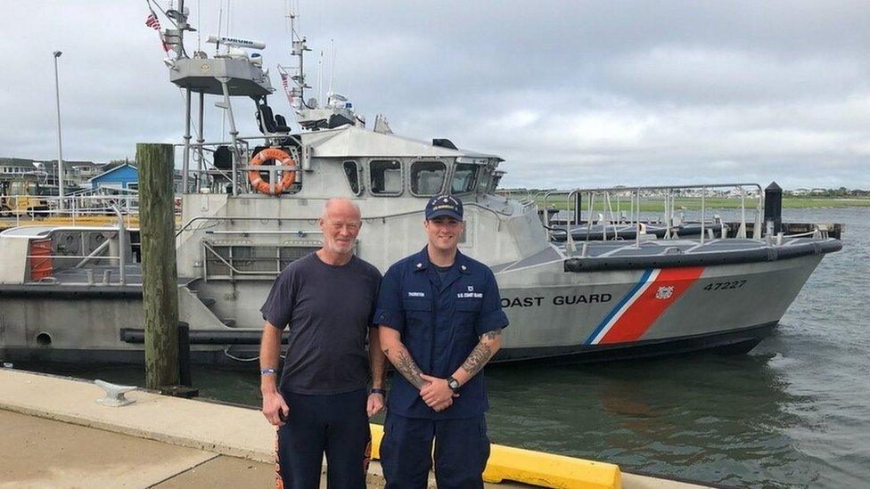 Duncan Hutchison with Petty Officer 2nd Class Eric Thornton, a surfman at Coast Guard Station Barnegat Light, poses for a photo with Duncan Hutchison