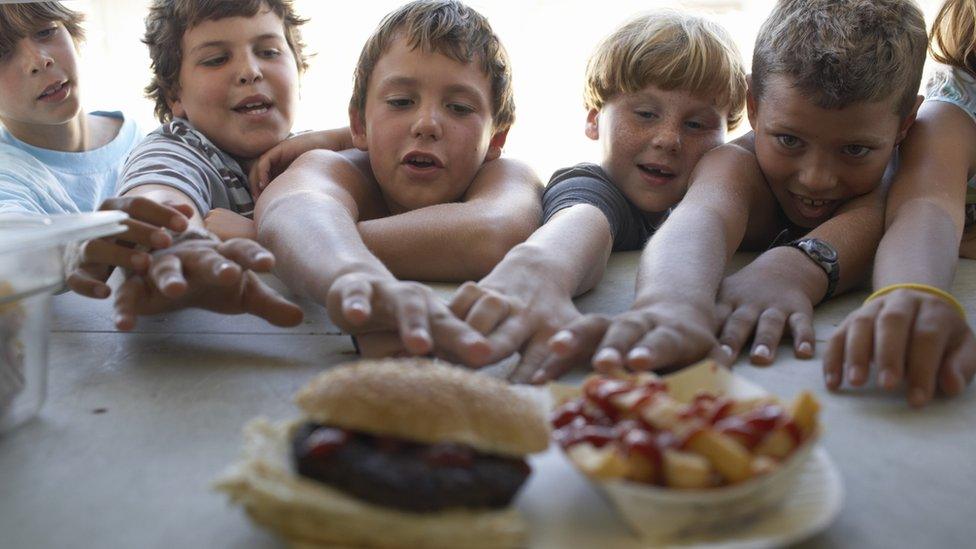 children reaching for fastfood