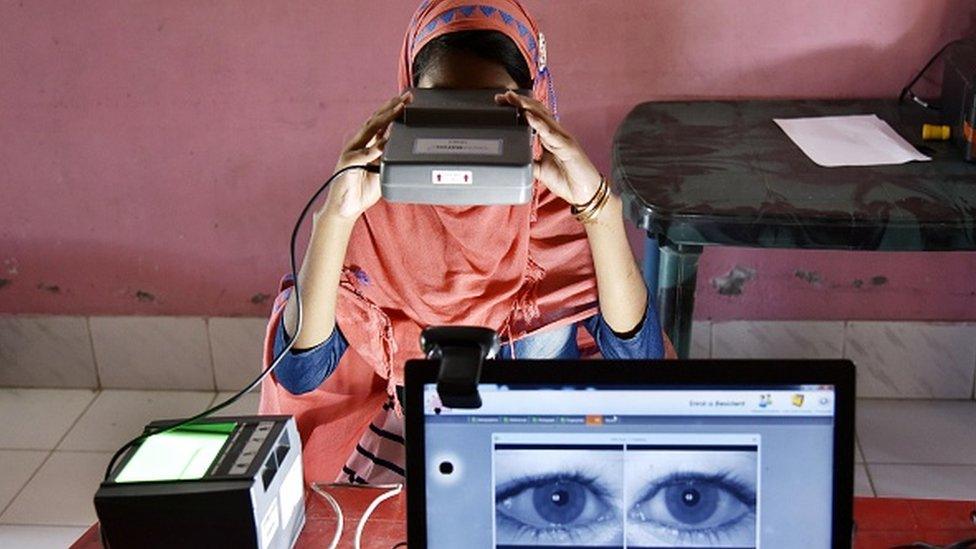 A woman takes an iris scan to link her Aadhar card with National Register of Citizens (NRC) during a hearing at a Passport Seva Kendra (PSK) in Barpeta district in the state of Assam, on August 10, 2019