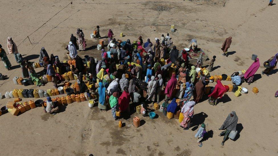 Women and children are seen gathered at the water point at the internally displaced peoples camp Muna camp in Maiduguri, Nigeria, December 1, 2016.