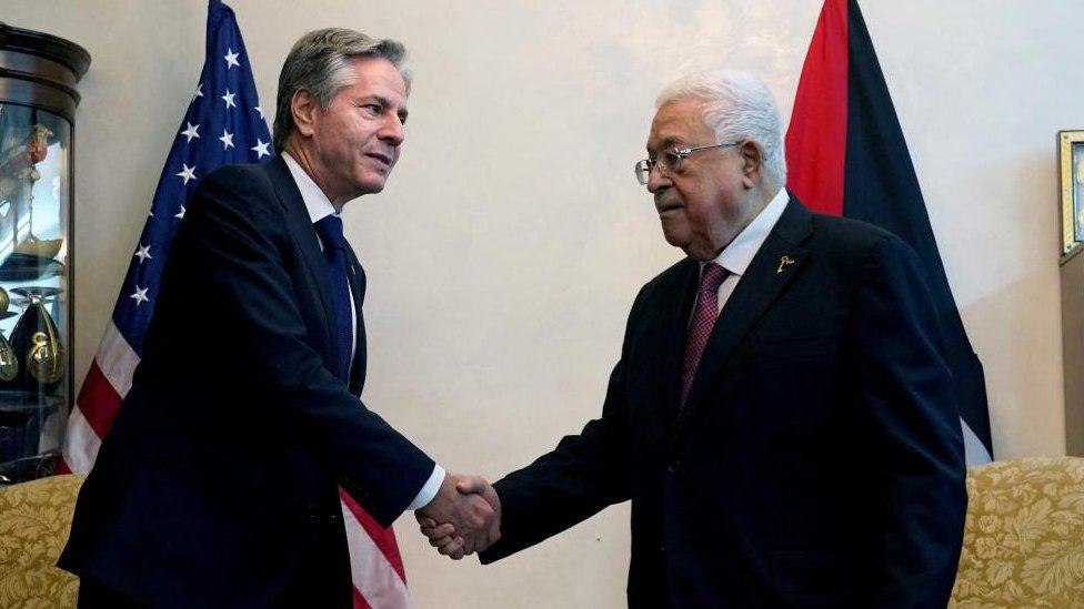 Antony Blinken shakes hands with Mahmoud Abbas