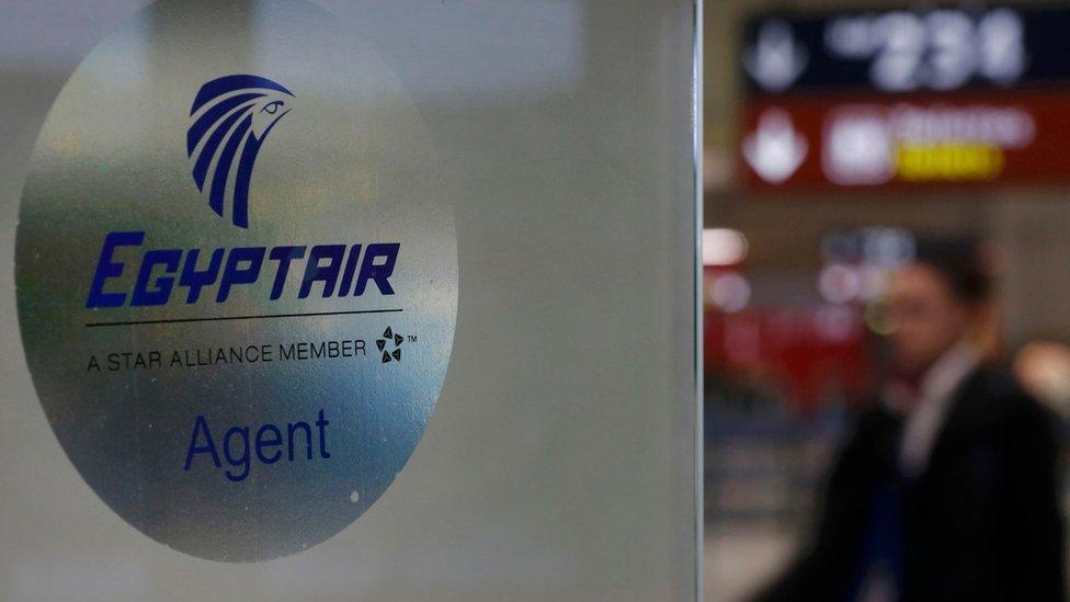 A man passes the Egyptair desk at Charles de Gaulle airport, after an Egyptair flight disappeared from radar during its flight from Paris to Cairo, in Paris, France, May 19, 2016. REUTERS/Christian Hartmann