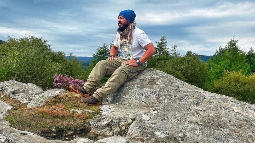 Chris Howard sitting on a rock