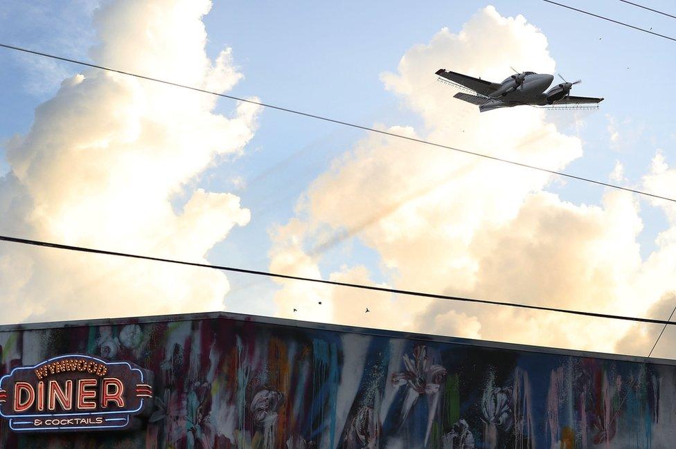 A plane sprays pesticide over the Wynwood neighbourhood in the hope of controlling and reducing the number of mosquitoes, some of which may be capable of spreading the Zika virus on August 6, 2016 in Miami, Florida