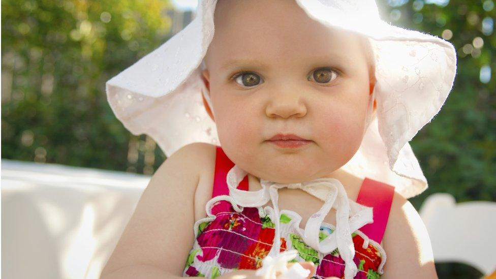 Young girl wearing a sun hat