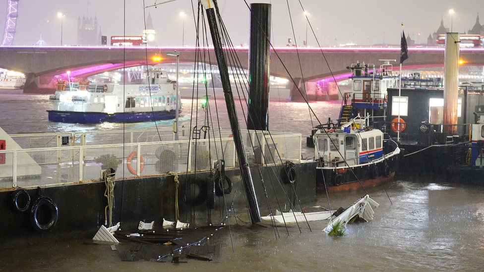 The mast of the Bar & Co boat, which was moored at Temple Pier juts from the water after the London party boat which acts as a floating bar, restaurant and nightclub sunk in the River Thames.