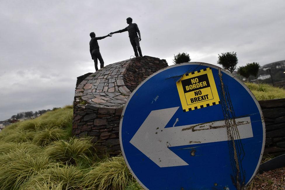 A No Border No Brexit sticker close to the Hands Across the Divide peace statue