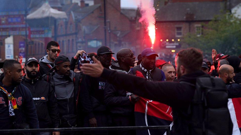 Paris Saint-Germain fans holding a flare