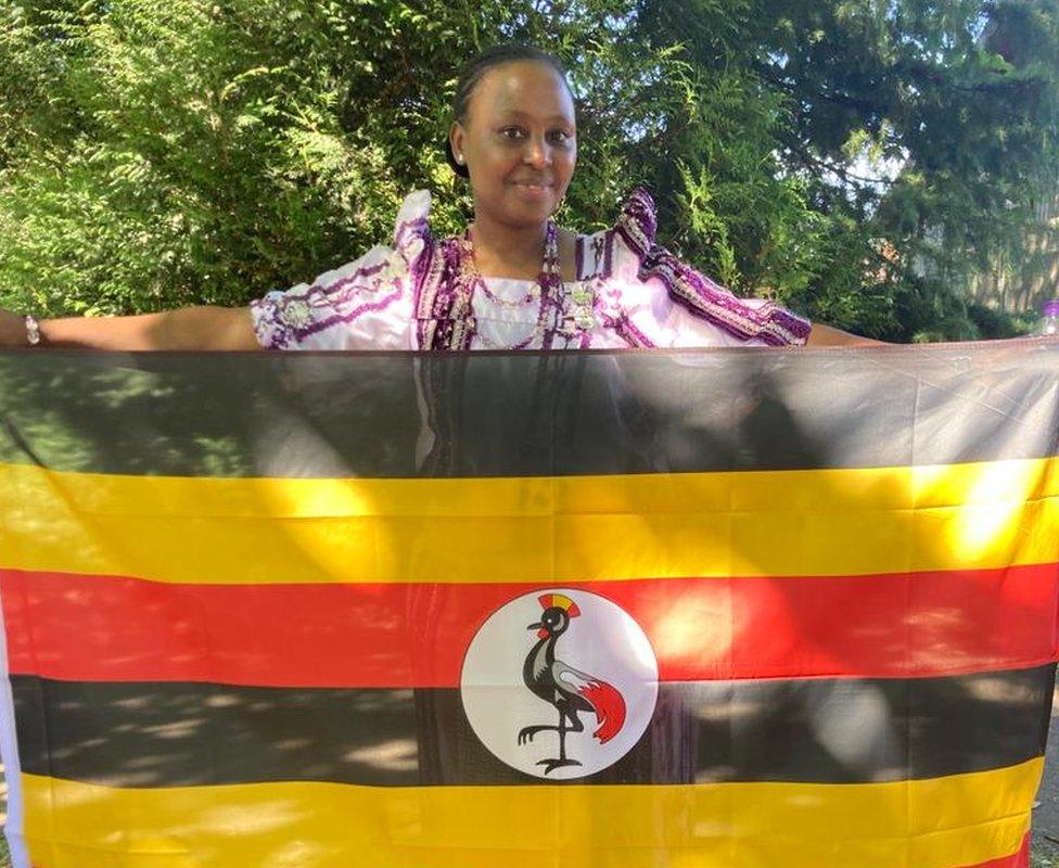 Juliet Nabaweesi holding up the Ugandan flag