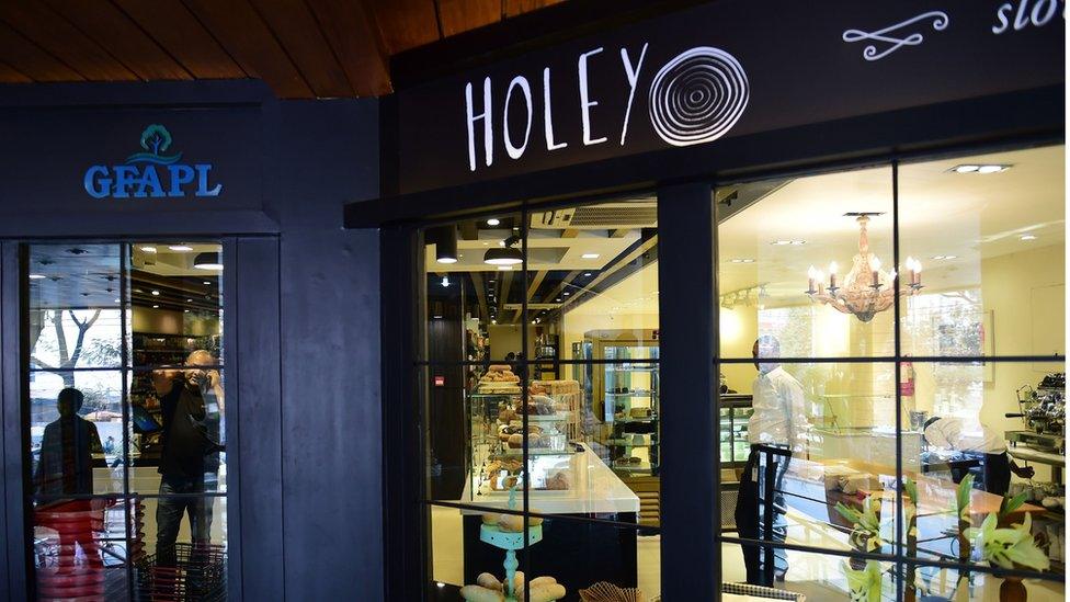 Employees stand inside the newly reopened Holey Artisan Bakery in Dhaka on January 11, 2017.