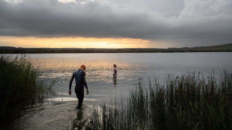 Two swimmers in the water at the lake