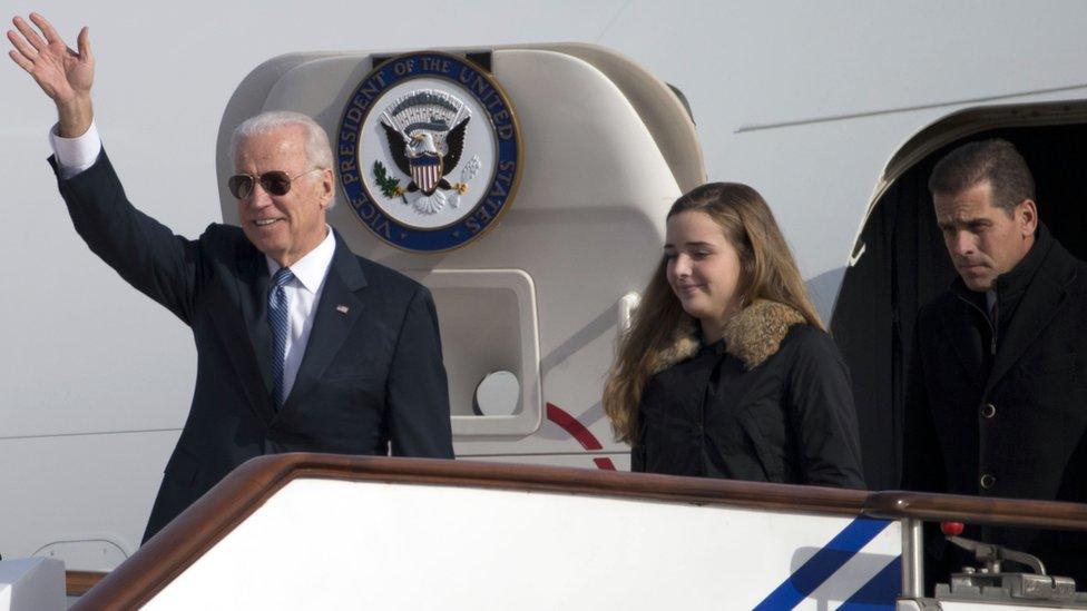 US Vice-President Joe Biden waves as he walks out of Air Force Two with his granddaughter Finnegan Biden (C) and son Hunter Biden (R) in Beijing, China, on 4 December 2013