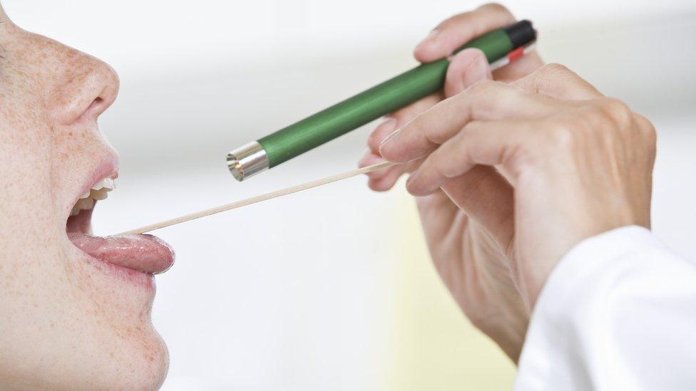 Woman having her tonsils checked