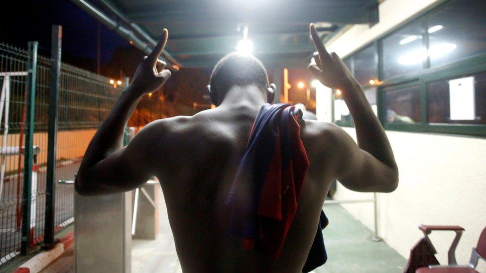 An African migrant reacts upon arriving at CETI, the short-stay immigrant centre, after crossing the border fence between Morocco and Spain"s north African enclave of Ceuta, December 9, 2016