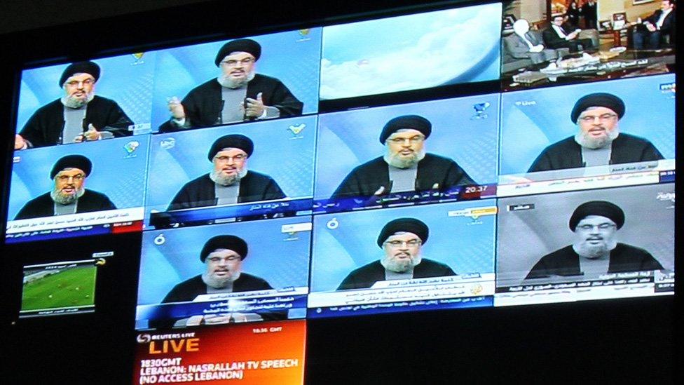 Lebanon's Hezbollah chief Hassan Nasrallah is seen on broadcast screens at Hezbollah owned al-Manar TV in Beirut during his speech on January 16, 2010.