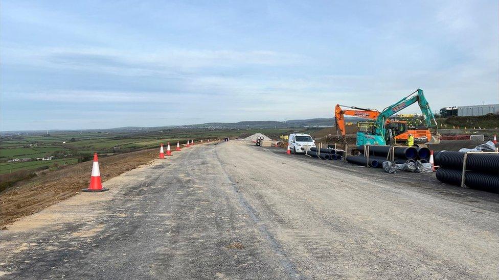 New A30 with roadworks machinery working on it